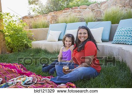 Stock Photo - Mother and daughter eating outdoors. Fotosearch
