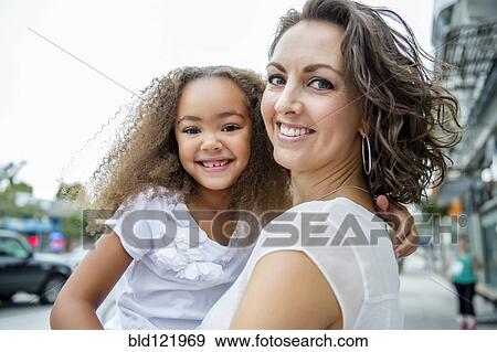 Mother and daughter smiling outdoors View Large Photo Image Stock Photo - Mother and daughter smiling outdoors. Fotosearch