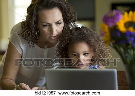 Stock Photo - Mother and daughter using laptop. Fotosearch