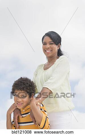 Stock Photo - Mother and son hugging outdoors. Fotosearch