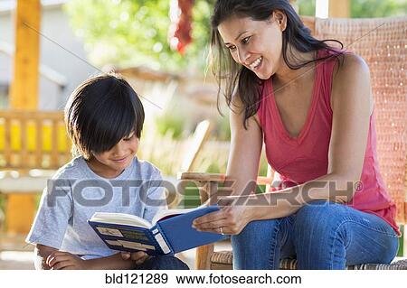 Stock Photo - Mother and son reading together on porch. Fotosearch