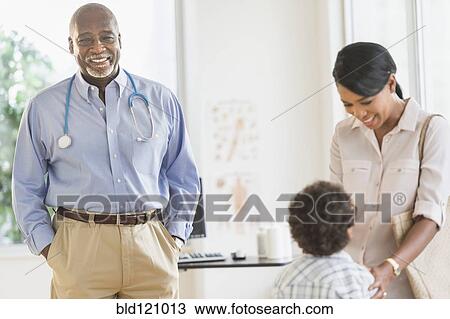 Stock Image - Mother and son seeing doctor. Fotosearch
