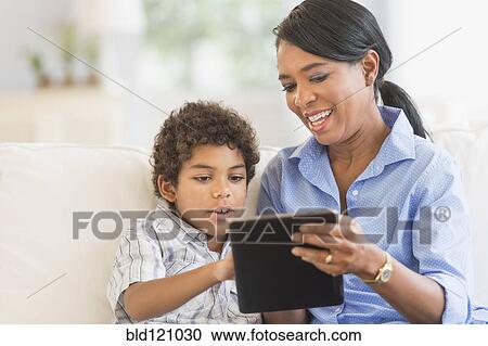 Stock Image - Mother and son using digital tablet. Fotosearch