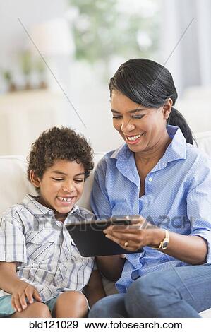 Mother and son using digital tablet View Large Photo Image Stock Photo - Mother and son using digital tablet. Fotosearch