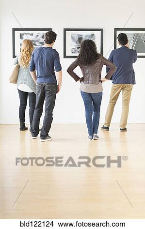 Picture - People admiring art in gallery. Fotosearch