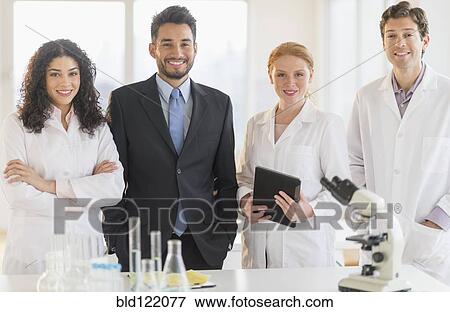 Scientists and businessman smiling in laboratory View Large Photo Image Stock Photo - Scientists and businessman smiling in laboratory. Fotosearch