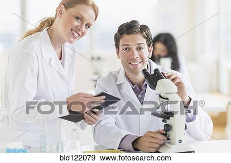 Stock Photo - Scientists working in laboratory. Fotosearch