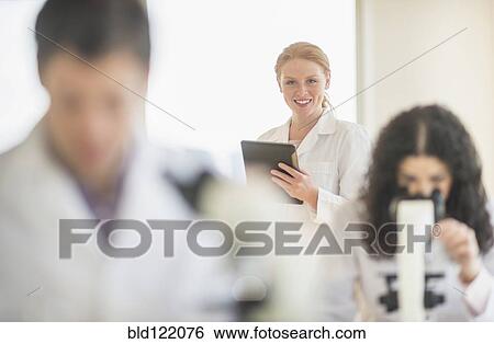 Stock Photograph - Scientists working in laboratory. Fotosearch