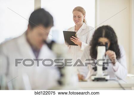 Scientists working in laboratory View Large Photo Image Stock Photography - Scientists working in laboratory. Fotosearch