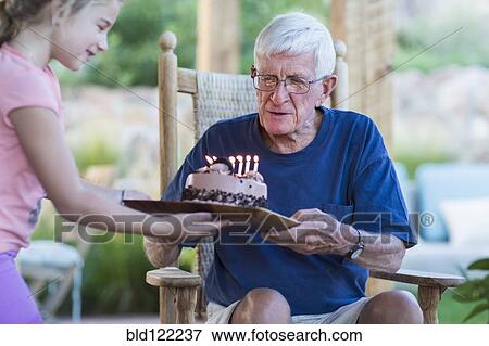 Senior Caucasian man celebrating birthday View Large Photo Image Stock Photo - Senior Caucasian man celebrating birthday. Fotosearch
