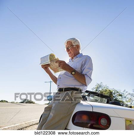Senior Caucasian man reading map by road View Large Photo Image Stock Photo - Senior Caucasian man reading map by road. Fotosearch