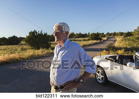 Senior Caucasian man standing on rural road View Large Photo Image Stock Image - Senior Caucasian man standing on rural road. Fotosearch