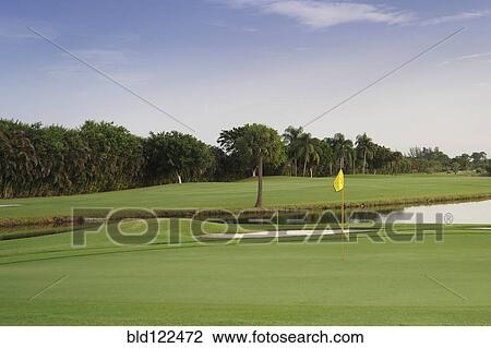 Stock Image - Still pond on golf course. Fotosearch