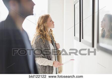 Woman admiring art in gallery View Large Photo Image Stock Image - Woman admiring art in gallery. Fotosearch