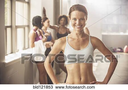 Stock Image - Woman smiling in gym. Fotosearch