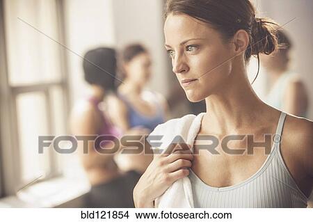 Picture - Woman standing in gym. Fotosearch