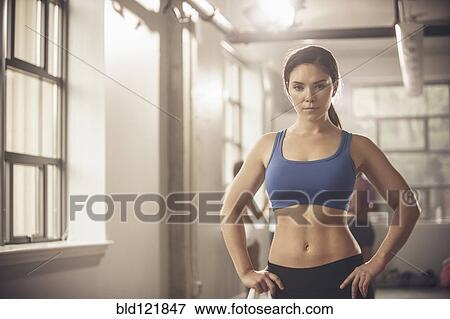 Woman standing in gym View Large Photo Image Stock Photo - Woman standing in gym. Fotosearch