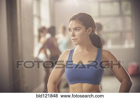 Stock Photo - Woman standing in gym. Fotosearch