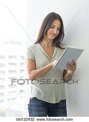 Stock Image - Woman using digital tablet. Fotosearch