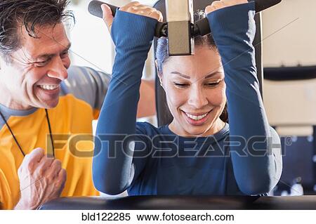 Woman working with personal trainer in gym View Large Photo Image Stock Photography - Woman working with personal trainer in gym. Fotosearch