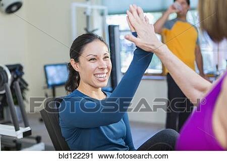 Women high-fiving in gym View Large Photo Image Stock Image - Women high-fiving in gym. Fotosearch