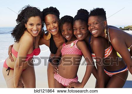 Picture - Women smiling together on beach. Fotosearch