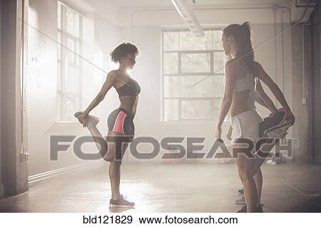Stock Photo - Women stretching in gym. Fotosearch