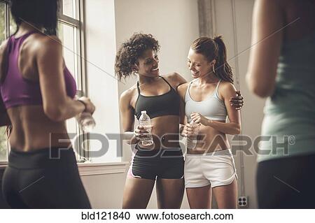 Women talking in gym View Large Photo Image Stock Image - Women talking in gym. Fotosearch