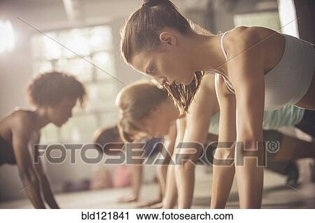 Stock Image - Women working out in exercise class. Fotosearch