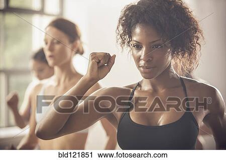 Women working out in exercise class View Large Photo Image Stock Image - Women working out in exercise class. Fotosearch