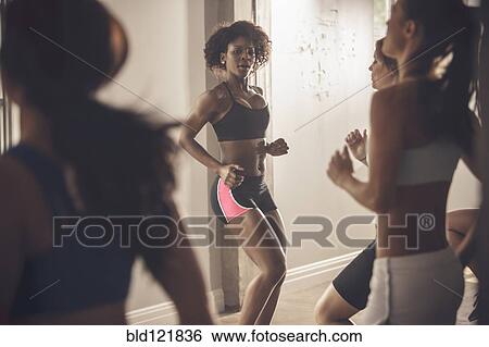 Stock Photograph - Women working out in exercise class. Fotosearch