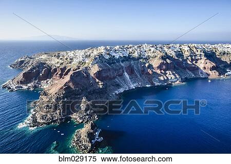 Aerial view of city built on rocky coastline, Oia, Egeo, Greece View Large Photo Image Stock Photography - Aerial view of city built on rocky coastline, Oia, Egeo, Greece. Fotosearch