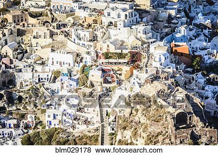 Stock Photo - Aerial view of city on hillside, Oia, Egeo, Greece. Fotosearch