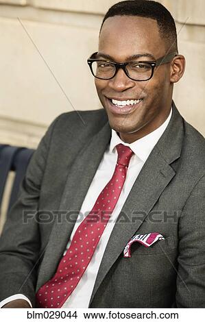 Picture - Black businessman smiling outdoors. Fotosearch