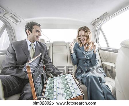 Stock Photography - Businessman showing suitcase of money to colleague. Fotosearch