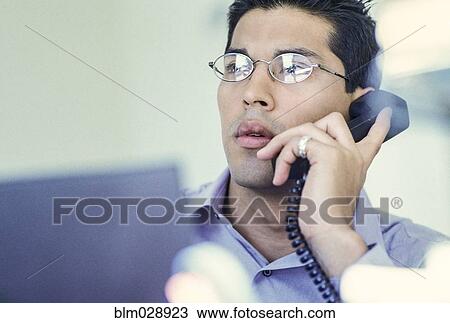 Stock Image - Businessman talking on telephone. Fotosearch