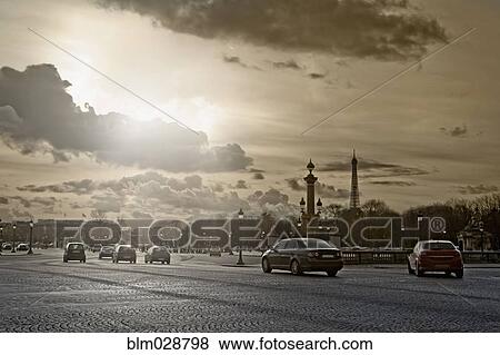 Stock Photo - Cars driving on city street, Paris, France. Fotosearch