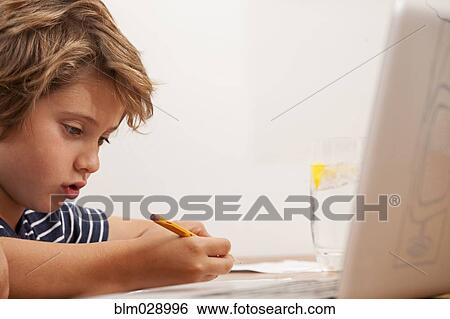 Caucasian boy doing homework View Large Photo Image Stock Photograph - Caucasian boy doing homework. Fotosearch