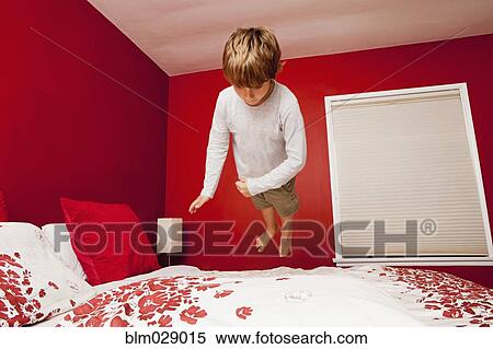 Caucasian boy jumping on bed View Large Photo Image Stock Photography - Caucasian boy jumping on bed. Fotosearch