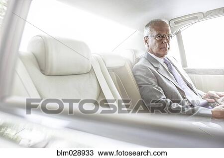 Stock Image - Caucasian businessman sitting in car. Fotosearch