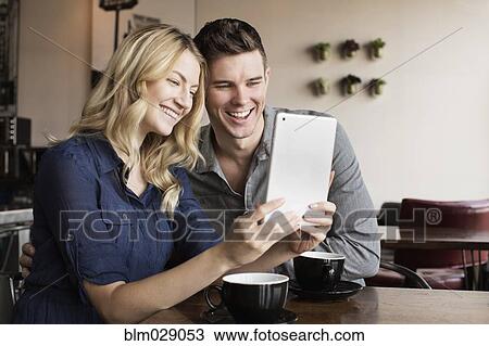 Caucasian couple using digital tablet together View Large Photo Image Stock Image - Caucasian couple using digital tablet together. Fotosearch