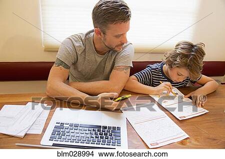 Caucasian father helping son with homework View Large Photo Image Picture - Caucasian father helping son with homework. Fotosearch