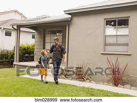 Caucasian father walking son to school View Large Photo Image Stock Photo - Caucasian father walking son to school. Fotosearch