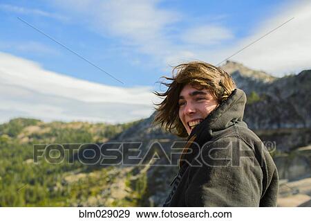 Stock Photo - Caucasian man smiling in rural landscape. Fotosearch