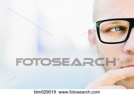 Stock Photo - Caucasian man wearing eyeglasses. Fotosearch
