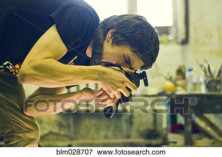 Caucasian photographer working in studio View Large Photo Image Stock Photo - Caucasian photographer working in studio. Fotosearch