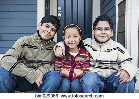 Stock Photograph - Children smiling together on front stoop. Fotosearch
