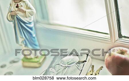 Close up of glasses, religious statue and fruit on windowsill View Large Photo Image Stock Photo - Close up of glasses, religious statue and fruit on windowsill. Fotosearch