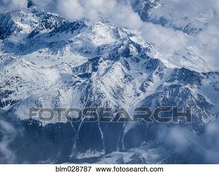 Clouds and snow covered mountains, Switzerland View Large Photo Image Stock Photo - Clouds and snow covered mountains, Switzerland. Fotosearch