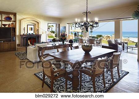 Dining table and sofa in open living space View Large Photo Image Stock Image - Dining table and sofa in open living space. Fotosearch